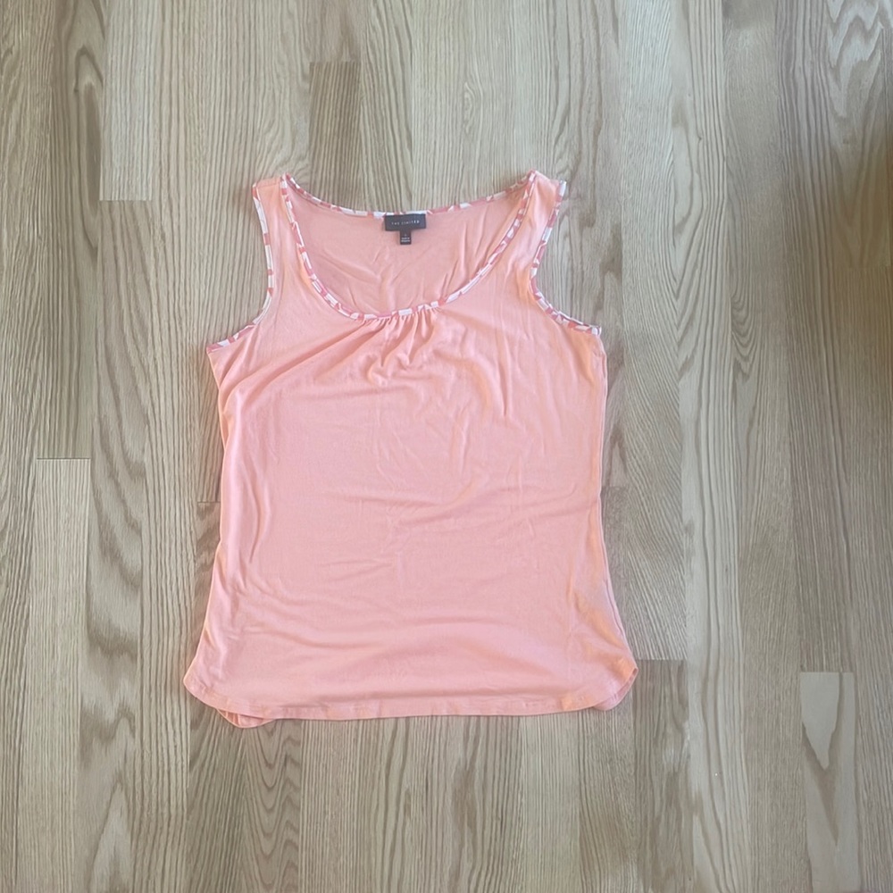 More of a coral color, size small, Limited tank is great for the summer.
